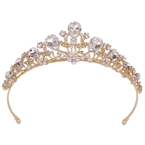 Detailed view of golden bridal tiara with rhinestones and floral leaf patterns