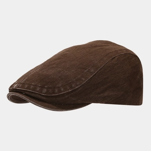 Detailed view of dark brown vintage flat cap showing reinforced stitching and twill fabric