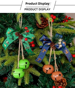Detail of Christmas iron bells with festive bows, pine cones and red berries on twine