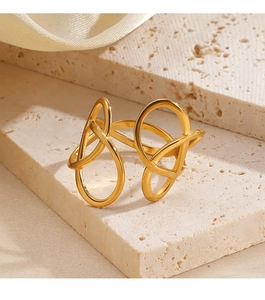 Detail view of gold abstract linear minimalist ring on natural textured stone background