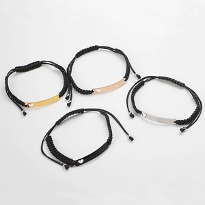Set of four adjustable woven wax cord bracelets with hollow heart curved metal plates