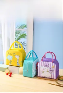 Three colorful insulated lunch bags with cartoon giraffe and cat prints on a sunlit windowsill