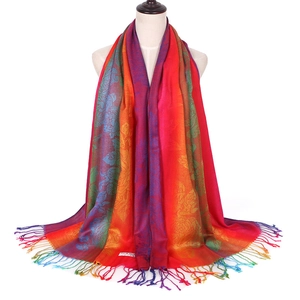 Close-up of ethnic colorful floral jacquard pattern and soft tassel details on scarf
