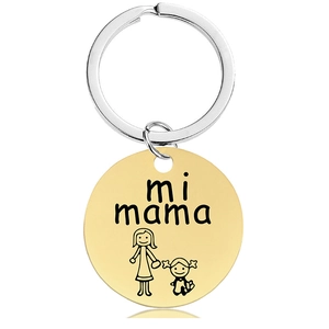 Macro detail of round gold pendant with Mi Mama engraving and mother-child line art