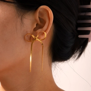 Elegant 18k gold-plated stainless steel bow earrings with snake chain tassels on model