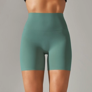 Close-up of high-waisted fitness shorts in sage green featuring seamless brushed fabric