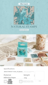 Close-up of vintage floral and bird stickers in a box with retro stamp patterns