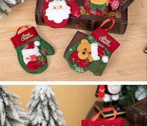 Detail of Christmas glove ornaments with Santa and snowman embroidery for tree decoration