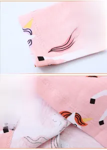 Detail of pink cotton dress showing unicorn print and durable double-needle sleeve stitching