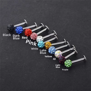 Macro view of colorful crystal disco ball labret studs in various stainless steel finishes