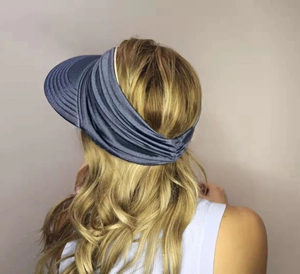 Detail view of the navy blue pleated fabric and elastic band on the women sun visor hat
