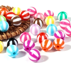 Close-up of colorful striped acrylic round beads for DIY jewelry and bracelet making