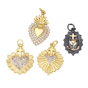 Golden and black heart charms with zircon crosses and religious motifs on white back