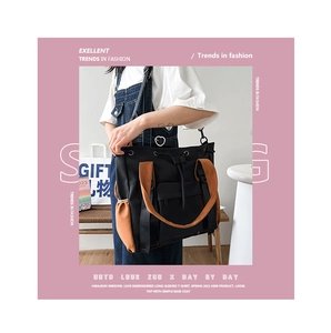 Detail of color-block tote bag featuring side pockets and adjustable shoulder strap