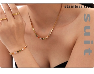 Detail of 18k gold plated stainless steel necklace and bracelet set with colorful zircons