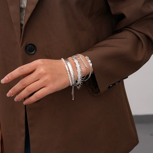 Close-up of bohemian silver multi-layer bracelets featuring ethnic embossed details