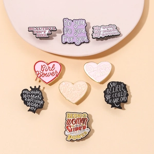 Detail of creative enamel letter pins and badges with motivational quotes for sweaters