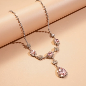 Gros plan du collier vintage avec pierres roses en poire et zircons blancs brillants
