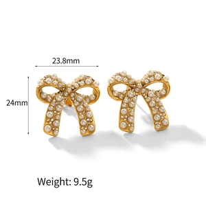 Detailed view of bow earrings with pearls and rhinestones showing 23.8mm x 24mm size
