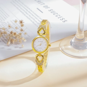 Detail of gold watch band with heart-shaped hollow links and sparkling rhinestones