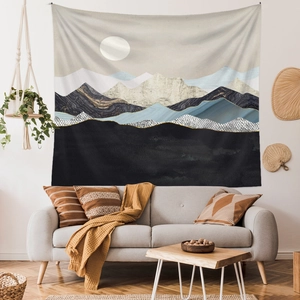 Detailed view of abstract mountain and sun tapestry in a modern minimalist living room setting