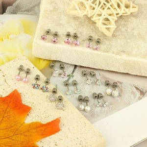 Set of 12 pairs of stud earrings featuring hearts, stars, and pearls on stone bases