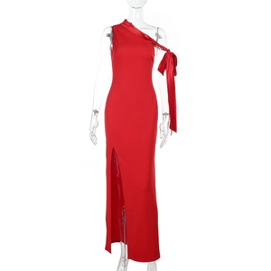 Détail d'une robe en satin rouge avec décolleté asymétrique élégant et nœud d'épaule