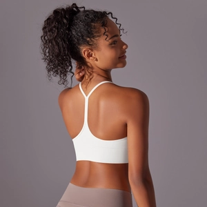 Close-up of white Y-back sports bra featuring minimalist thin straps and elastic fabric