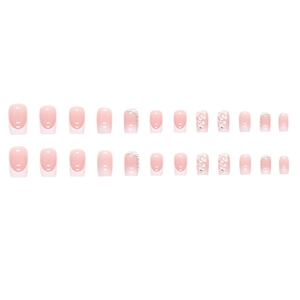 French gradient press-on nails with white floral accents and crystals in 24-piece set