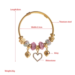 Macro detail of gold-plated titanium steel bracelet with rhinestones and heart charms