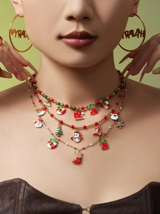 Close-up of layered Christmas necklace with enamel Santa, snowman and snowflake pendants