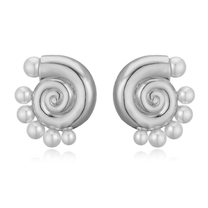 Macro detail of silver seashell spiral earrings with high-polish metallic texture