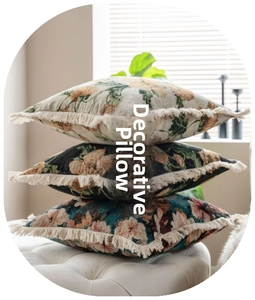 Three retro floral cushions with decorative tassels stacked on a white leather bench seat
