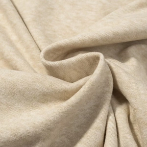 Macro texture of soft heather beige knit fabric showing high-quality fiber detail