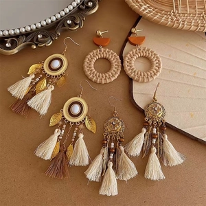 Bohemian tassel earrings with metal leaves and woven straw details for beach vacations