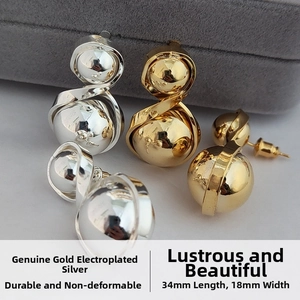 Detailed view of dual-ball gold plated stud earrings measuring 34mm by 18mm
