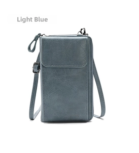 Detailed macro view of light blue multi-functional crossbody phone bag with pebble texture
