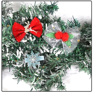 Detailed view of Christmas hair clips featuring reindeer, bows and snowflake designs