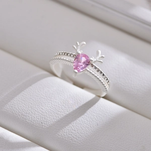 Macro shot of silver deer antler ring with pink teardrop stone and zircon accents