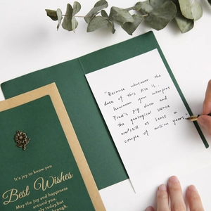 Vintage green card with gold foil Best Wishes text, metal flower, and kraft envelope