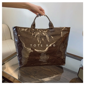 Detail of a brown crinkled Tyvek tote bag with white TOTE BAG text print