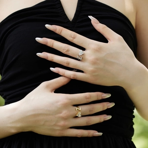 Detail of adjustable S925 silver heart and Z letter rings with zircon on model's fingers
