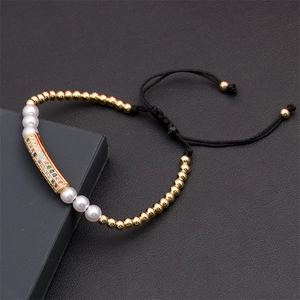 Detailed view of adjustable woven bracelet with rainbow zircon bead and gold copper beads