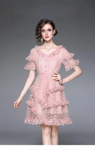 Close-up of pink lace dress featuring exquisite V-neckline and layered ruffle details
