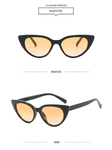 Detail view of retro cat-eye sunglasses with black glossy frames and tea gradient lenses