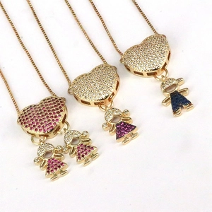 Zirconia heart necklace featuring cute boy and girl cartoon pendants in gold finish