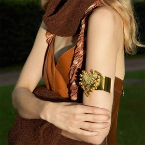 Artistic gold heart-shaped upper arm cuff bracelet with a textured metallic finish