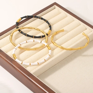 Bamboo style stainless steel C-shaped open bracelets in gold and enamel finishes