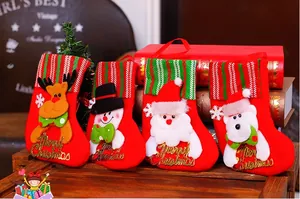 Set of four red velvet Christmas stockings with cartoon characters and gold lettering