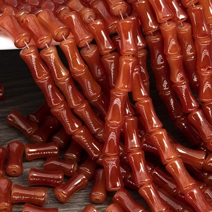 Macro shot of red agate bamboo-shaped beads for DIY jewelry making and necklaces